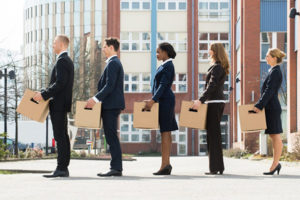 Businesspeople with boxes standing in a line