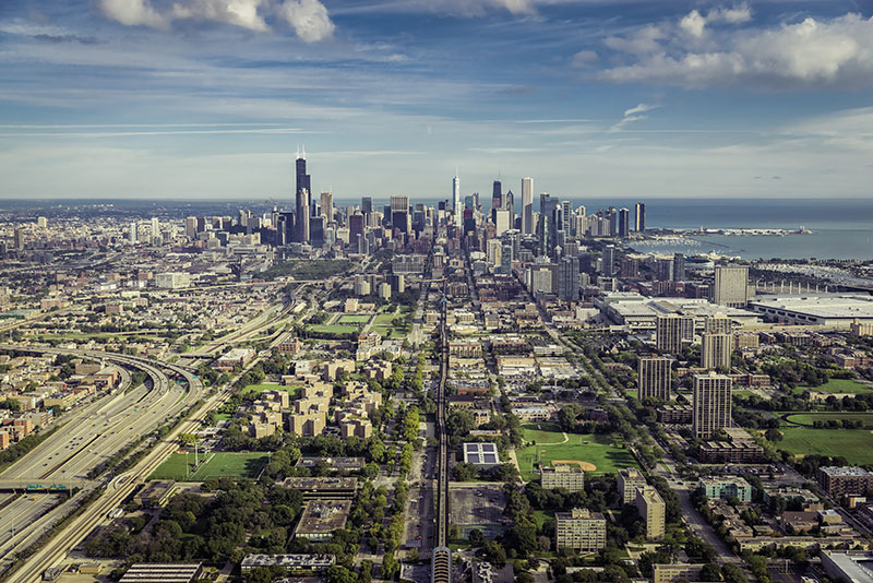 Aerial view through Chicago Downtown with suburbs