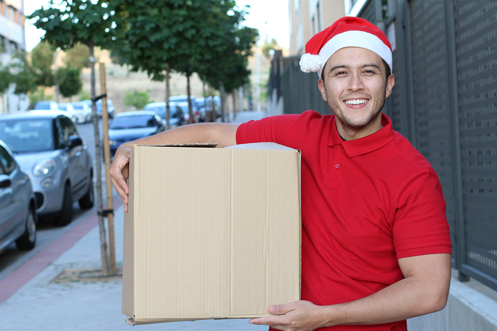 delivery man wearing christmas hat